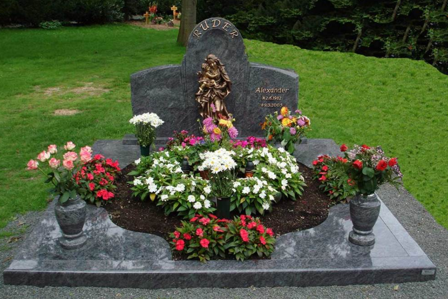 цветник из гранита с красными розами